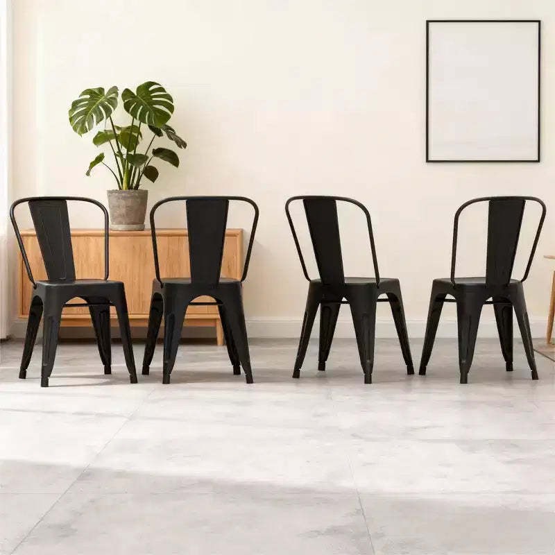 Dyonery 4 black metal chairs, with multi-hole seat designs and backrest arcs that conform to the curves of the human back