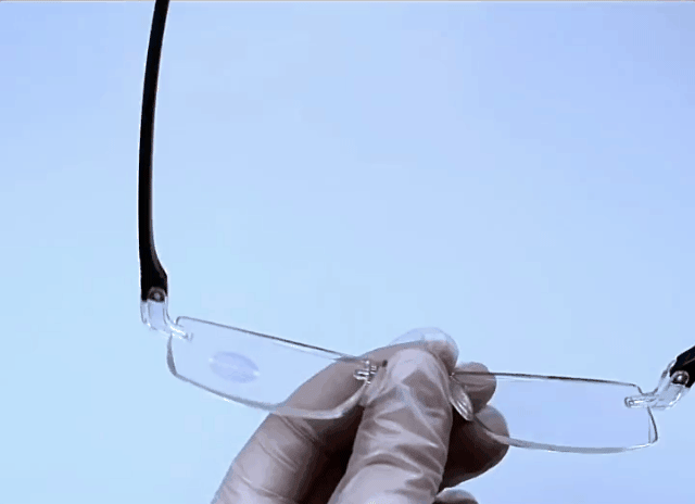 Senior man using progressive reading glasses while reading digital device