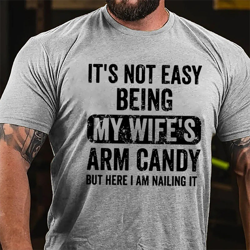 It's Not Easy Being My Wife's Arm Candy But Here I Am Nailing It Cotton T-shirt -Maturelion