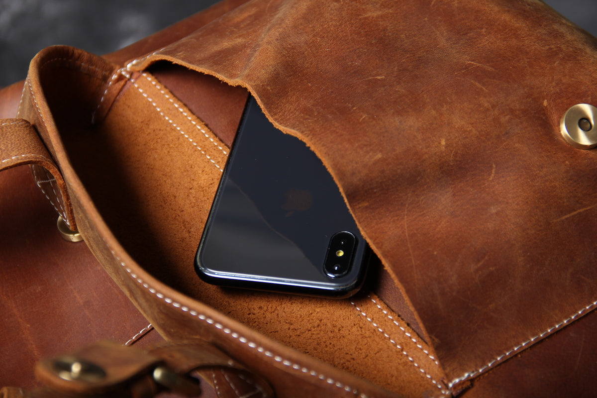 genuine leather carry on backpack with sturdy stitching and webbing