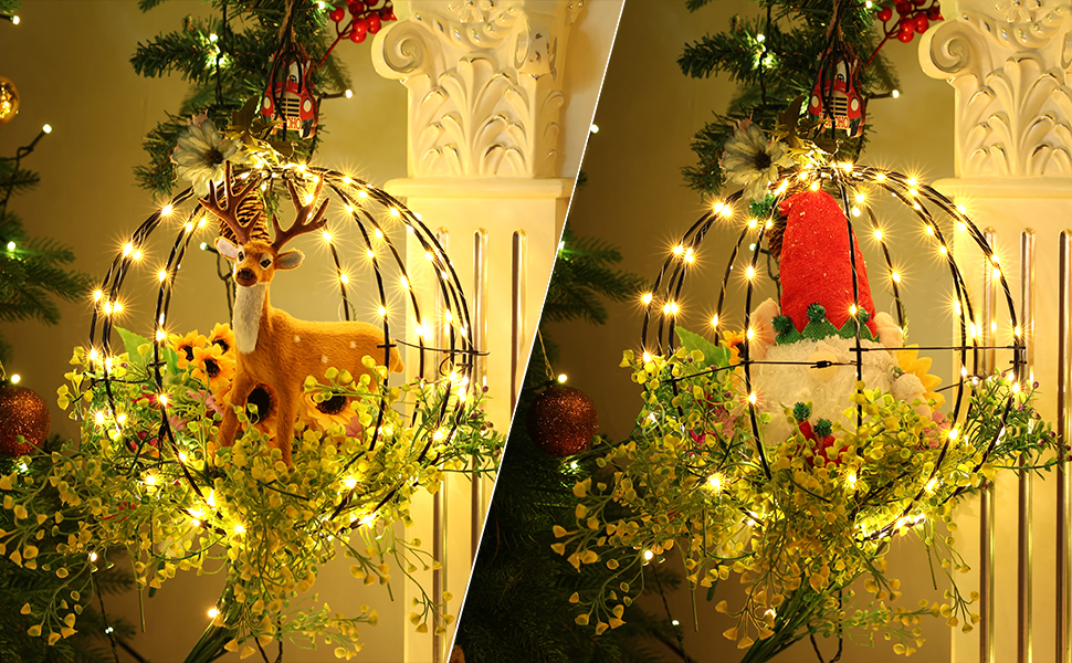 Two decorative spherical wire frames with LED lights and artificial greenery. One features a gold star, the other a red bell-shaped ornament.