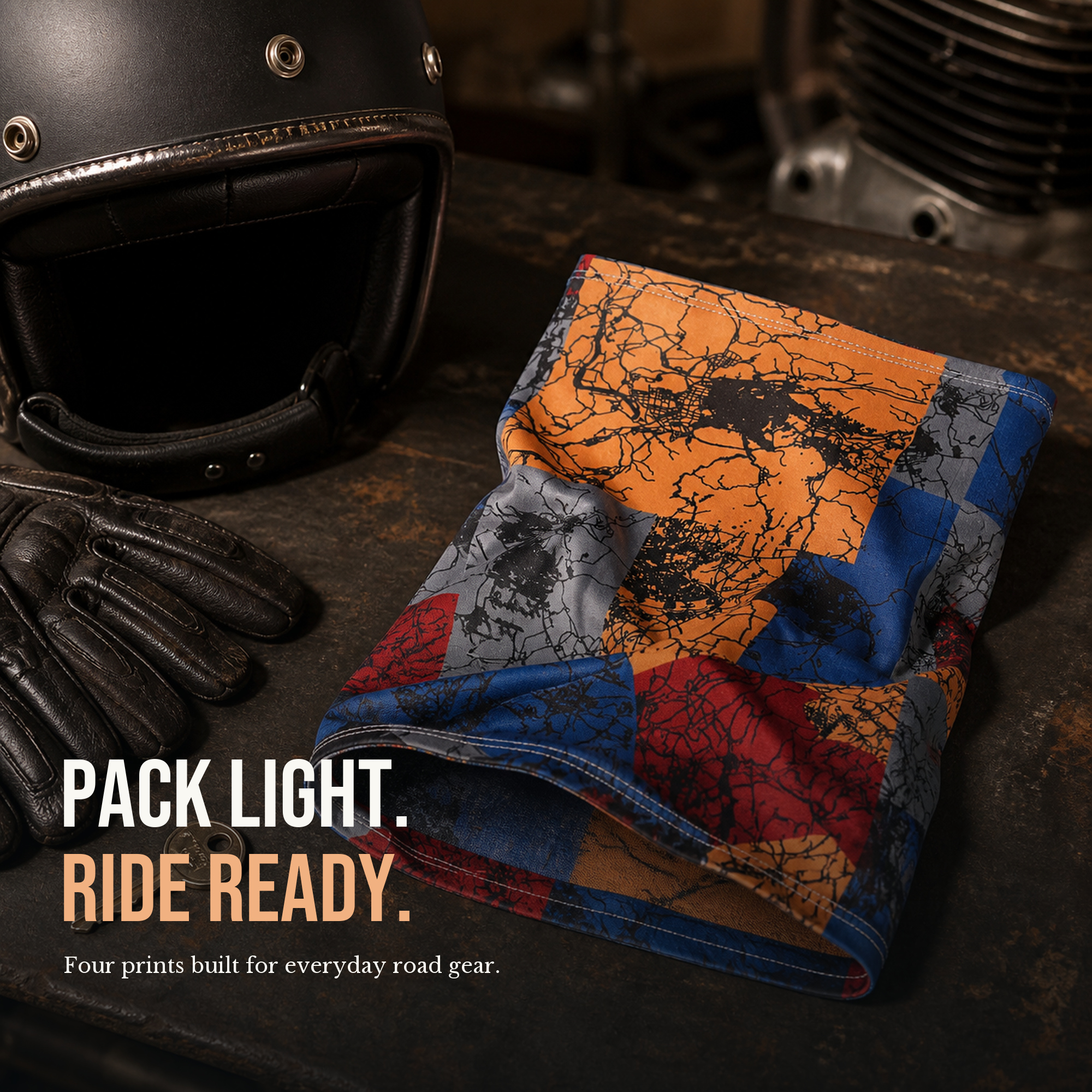 Soft neck gaiter folded compactly beside motorcycle road gear