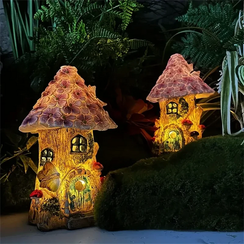 Two small, illuminated fairy houses resembling mushrooms sit in a garden at night. The houses have textured caps and glowing windows and doors.