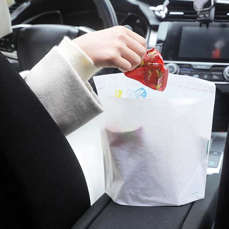 A self-adhesive trash bag in a car interior