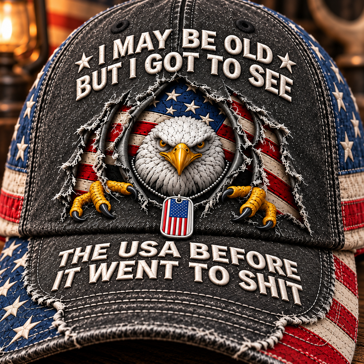 Close-up of the eagle illustration, distressed front, ivory slogan lettering and stitched curved brim