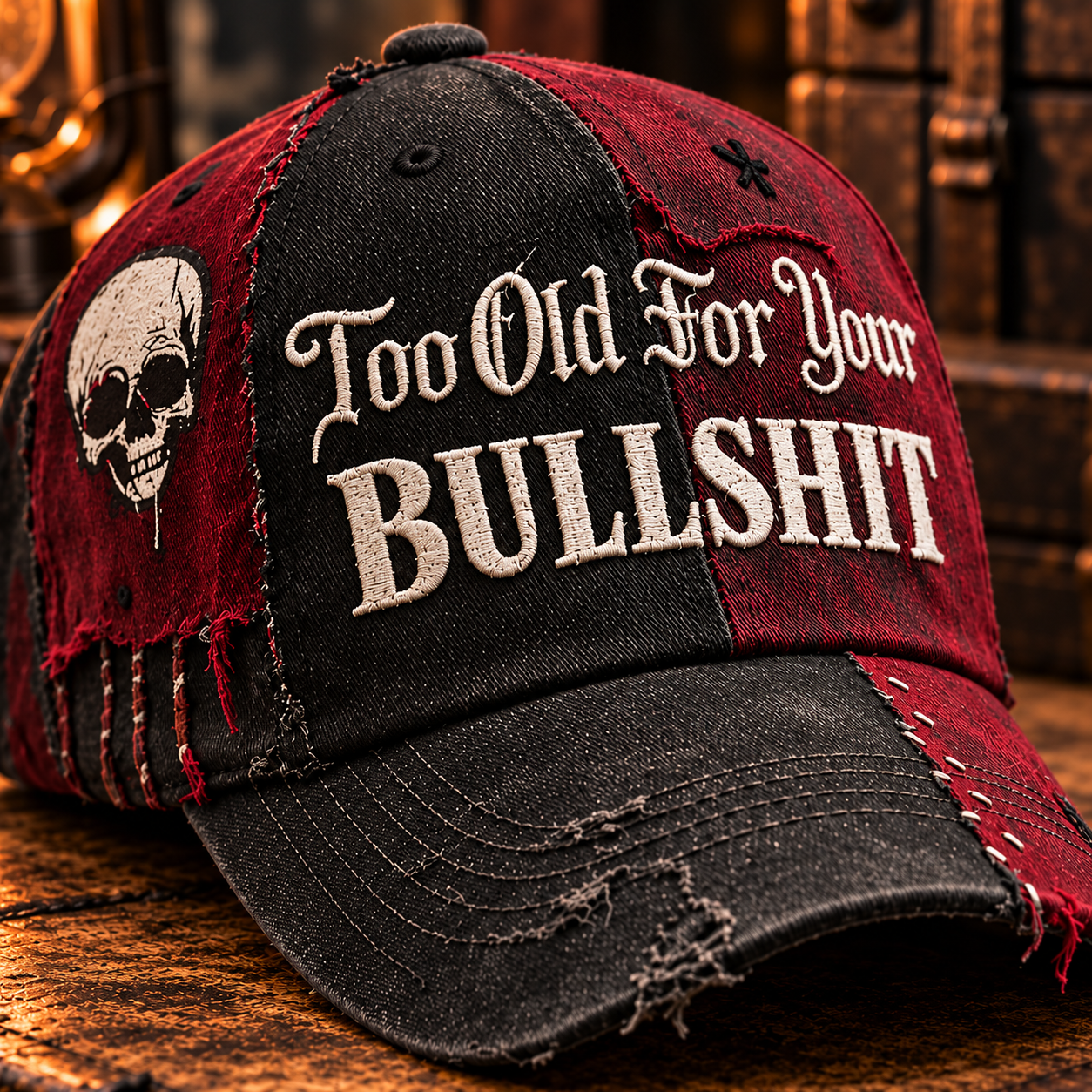 Close view of black and burgundy panels, pale slogan lettering, side skull and frayed patchwork seams