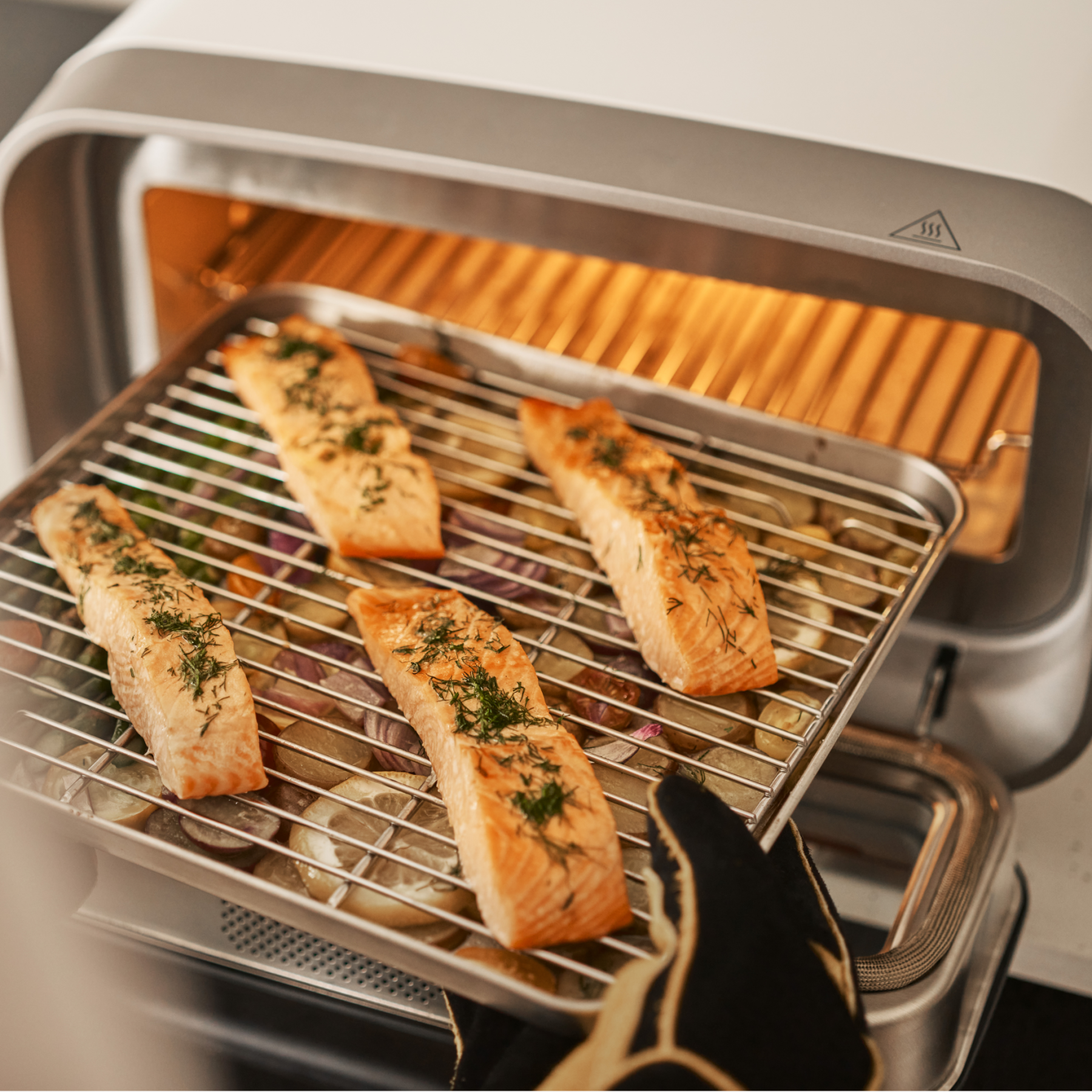 salmon fillets cooking on ooni sheet pan and rack for ooni volt 2