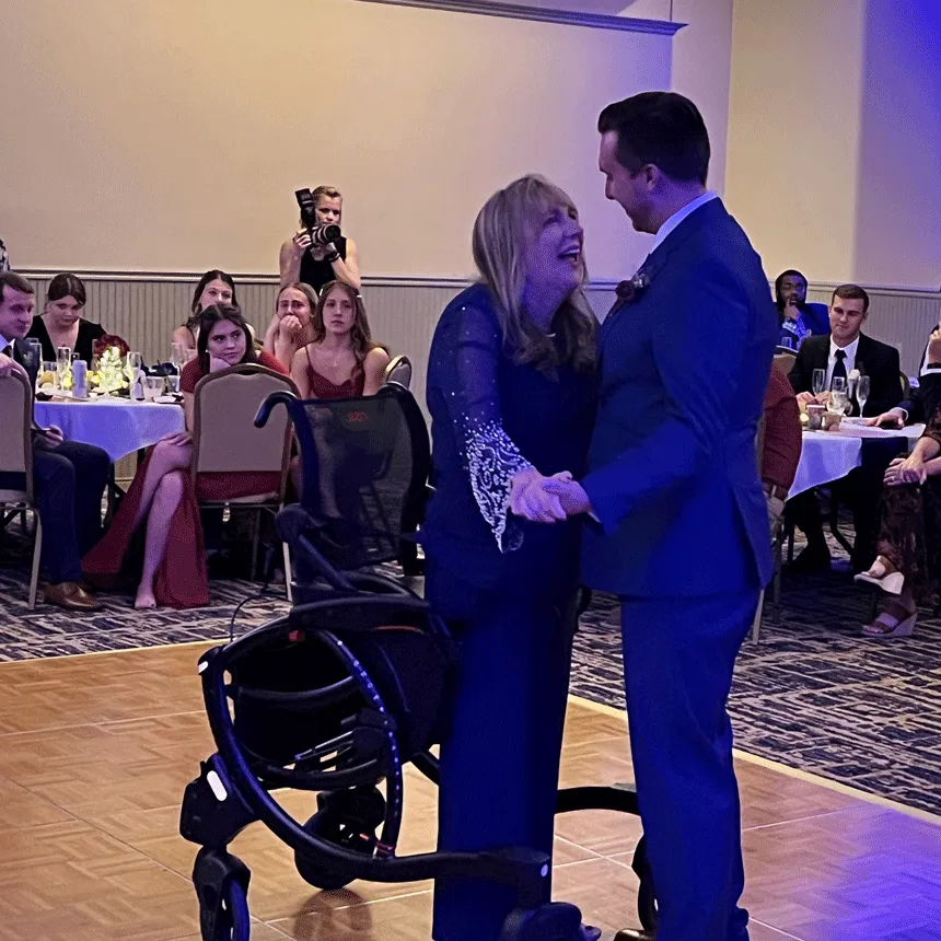 Sit-to-stand wheelchair walker
