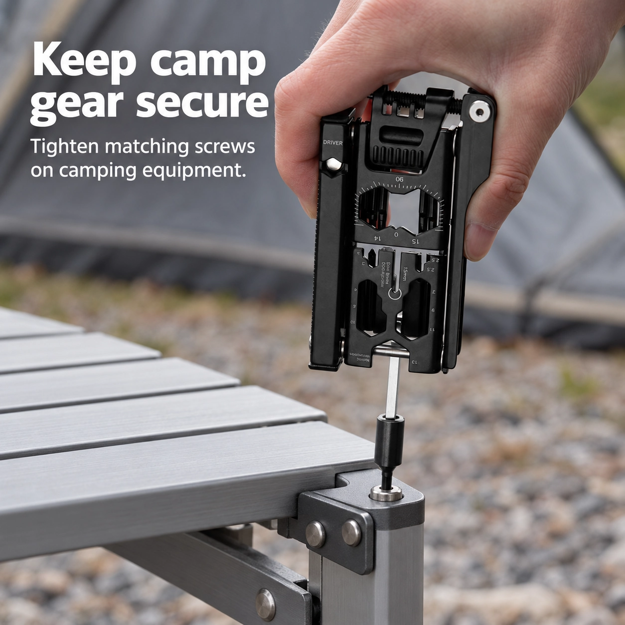Black bike multitool tightening a top-facing bolt on a folding camping table bracket