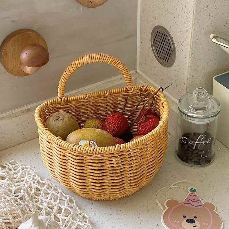 Wall-mounted rattan-like woven basket for storing green onions, ginger, and garlic in the kitchen