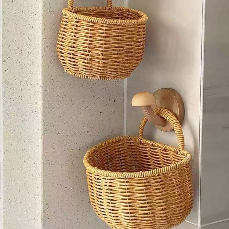 Wall-mounted rattan-like woven basket for storing green onions, ginger, and garlic in the kitchen