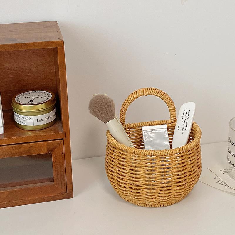 Wall-mounted rattan-like woven basket for storing green onions, ginger, and garlic in the kitchen