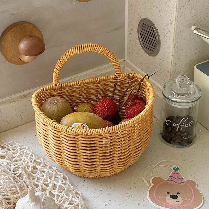 Wall-mounted rattan-like woven basket for storing green onions, ginger, and garlic in the kitchen