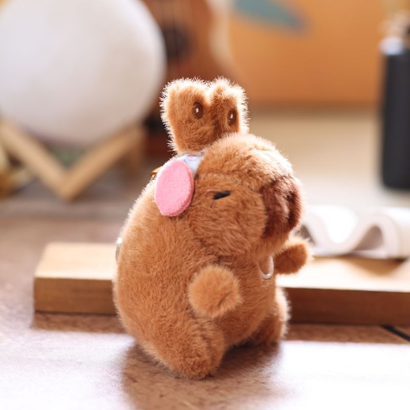 Cute and adorable capybara pendant plush toy with pullable moving rabbit ears, a backpack accessory