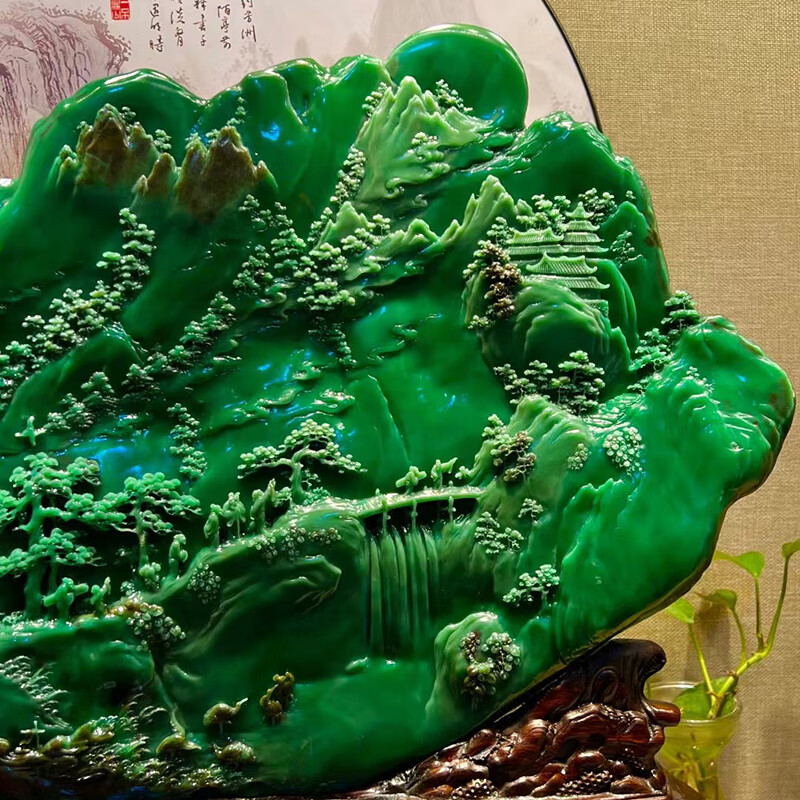 Hand-carved ornament of emerald green rural scenery