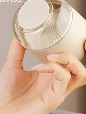 Handheld lint remover removing fuzz from clothes