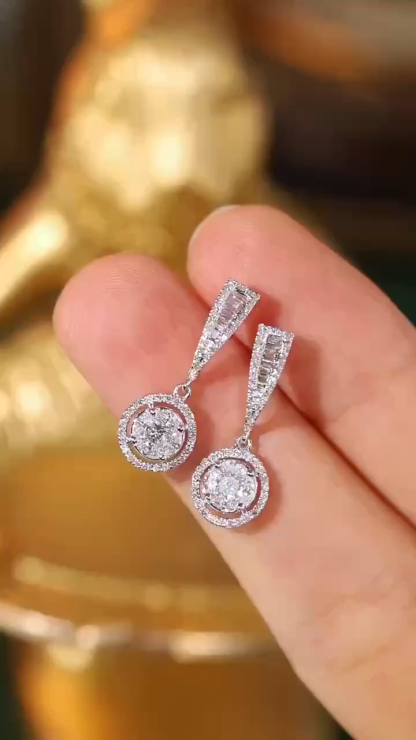 18k earrings set with a 0.60ct natural diamond; featuring a combination of marquise and princess cut diamonds.