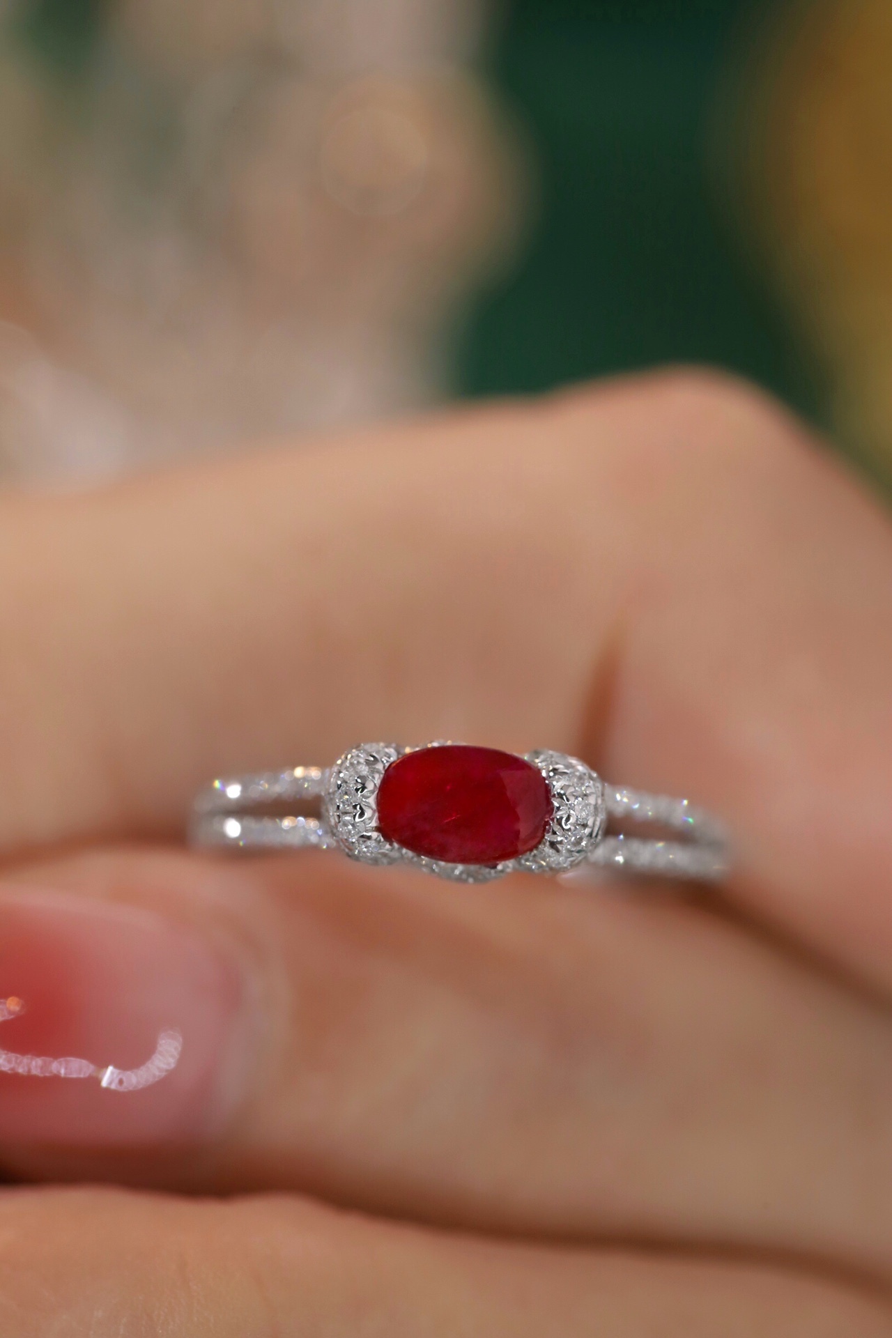 Set with 0.40 carats of natural diamonds and 0.60 carats of natural rubies, this 18K gold ring is oval in shape and is crafted using the four-prong setting technique.