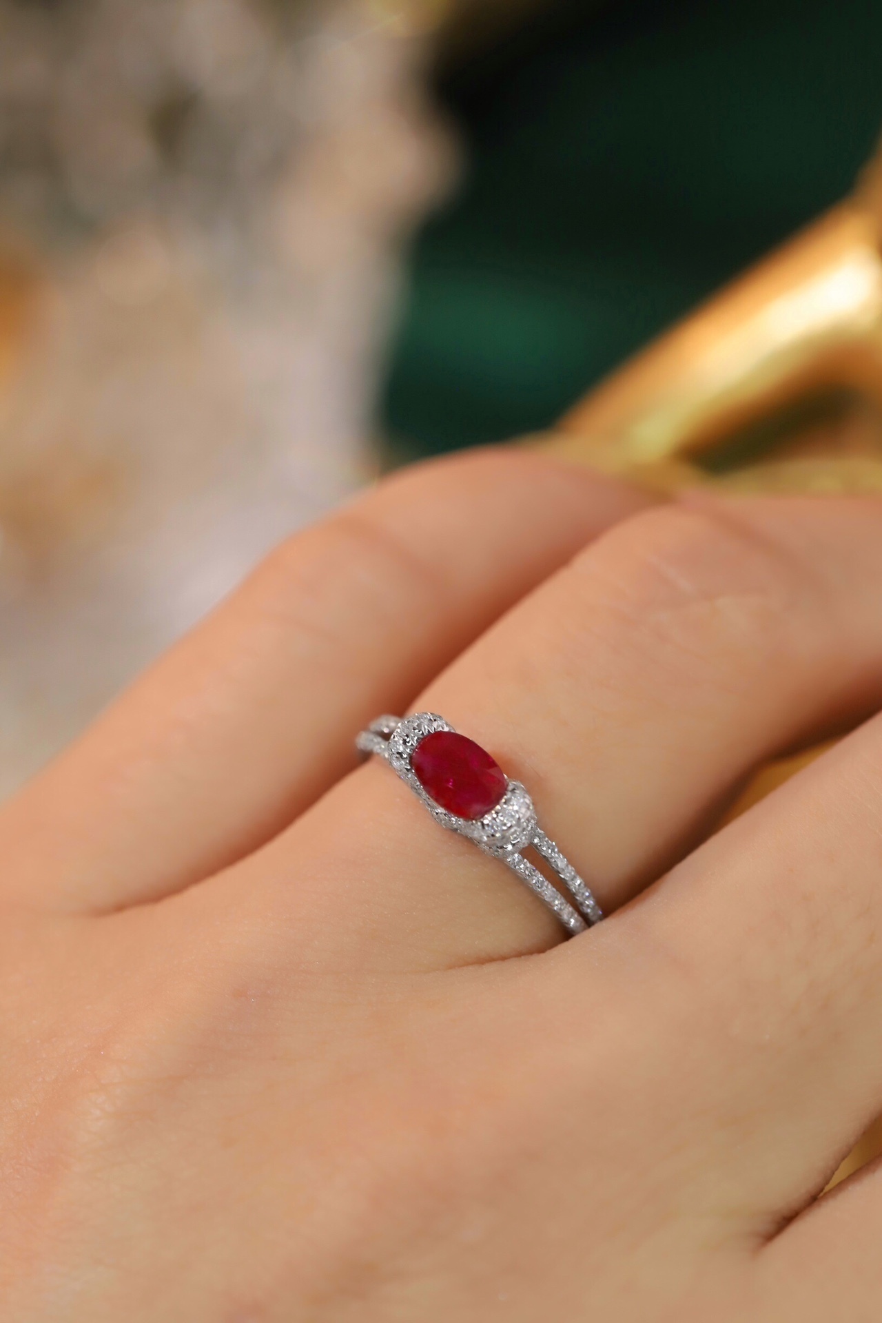 Set with 0.40 carats of natural diamonds and 0.60 carats of natural rubies, this 18K gold ring is oval in shape and is crafted using the four-prong setting technique.