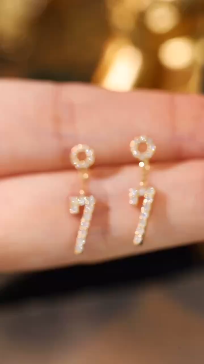 18k gold earring stud set with 0.30ct natural diamond and the number “7” embossed on it.