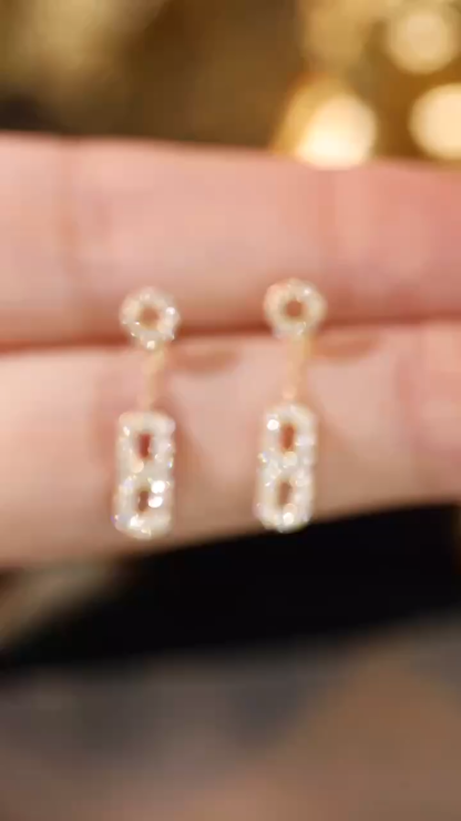 [18k gold earring stud set with 0.40ct natural diamond and the number “8” embossed on it.