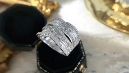 18k gold ring set with a natural diamond; the diamond features a Tapered Baguette cut and weighs 1.45carats.