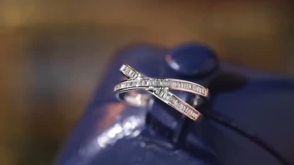 18k gold ring set with a natural diamond; the diamond features a Tapered Baguette cut and weighs 0.40 carats.