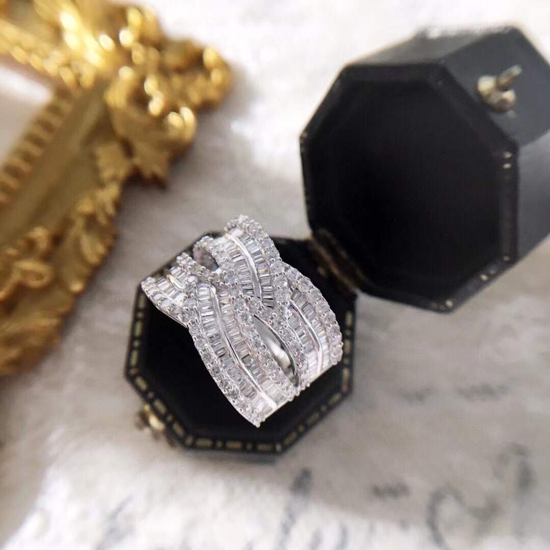 18k gold ring set with a natural diamond; the diamond features a Tapered Baguette cut and weighs 1.45carats.