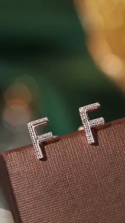 18k gold earring stud with the letter “F” and a 0.06ct natural diamond inlaid.