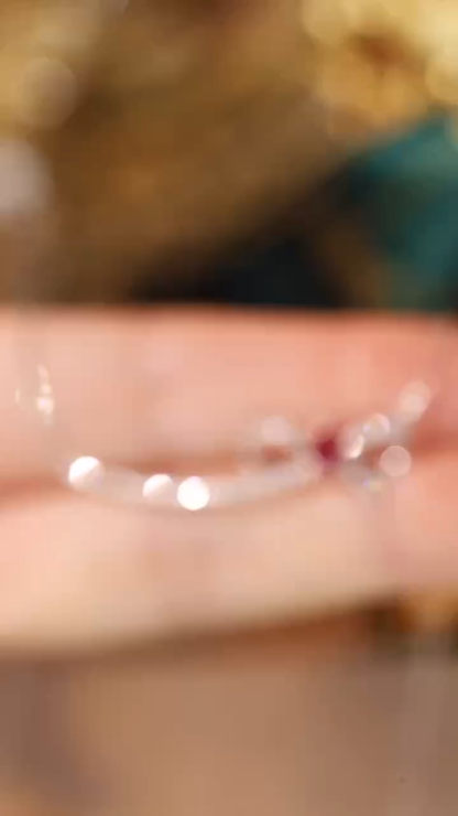 18k gold necklace with a bow design; the main diamond is 0.25 carats, and the side stone is also 0.25 carats.