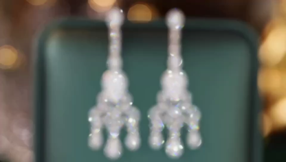 18k gold earrings set with a 1.10-carat natural diamond, featuring a vintage design.