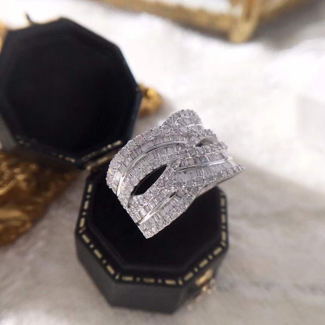 18k gold ring set with a natural diamond; the diamond features a Tapered Baguette cut and weighs 1.45carats.