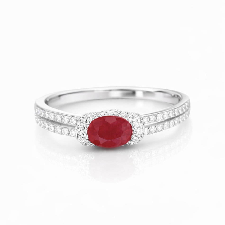 Set with 0.40 carats of natural diamonds and 0.60 carats of natural rubies, this 18K gold ring is oval in shape and is crafted using the four-prong setting technique.