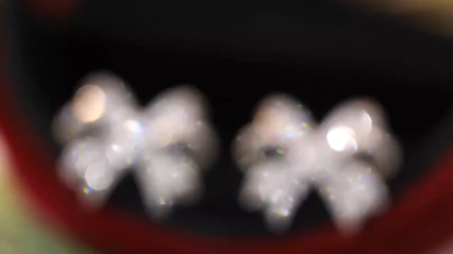 18-karat gold earrings in the shape of a butterfly, featuring a natural diamond of 1.00 carats set in a tapered baguette cut within a channel setting.
