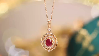 18k gold necklace set with an oval ruby of 0.45 carats, as well as additional stones of 0.15 carats each.