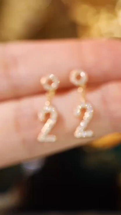 18k gold earring stud set with a 0.36ct natural diamond and the number “2” embossed on it.