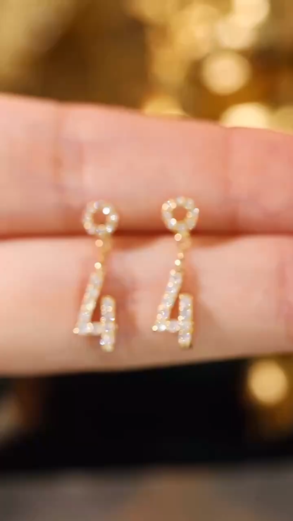 18k gold earring stud set with 0.32ct natural diamond and the number “4” embossed on it.
