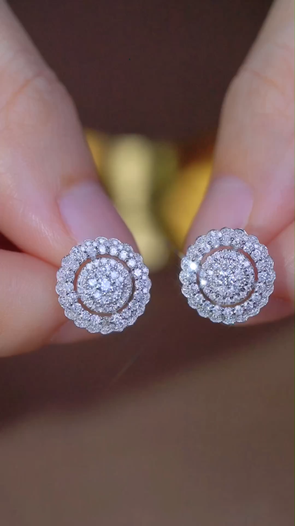 18k gold earrings set with a 1.00-carat natural diamond in a cluster setting.