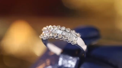 18k gold ring set with a natural diamond; the diamond features a Tapered Baguette cut and weighs 0.60carats.