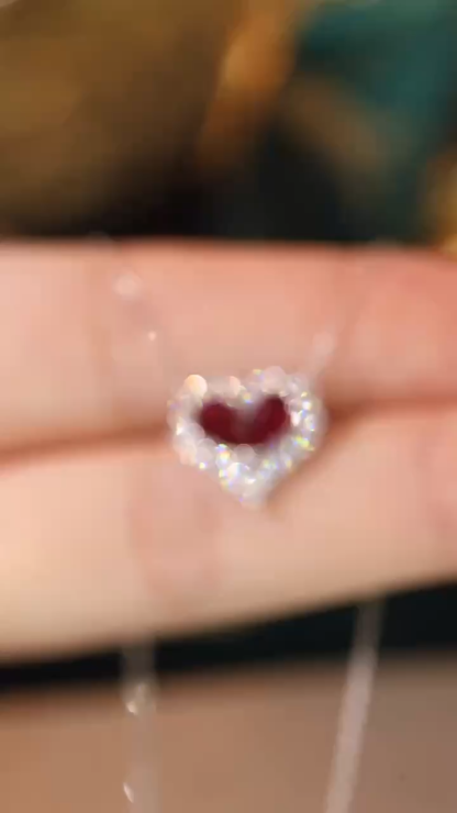 Heart-shaped 18k gold necklace set with a 0.92-carat ruby and a 0.45-carat diamond.