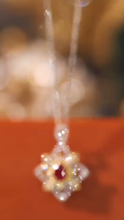 18k gold necklace set with an oval ruby of 0.38 carats, as well as additional stones of 0.22 carats each.