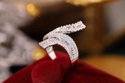 18k gold ring set with a natural diamond; the diamond features a Tapered Baguette cut and weighs 0.72carats.