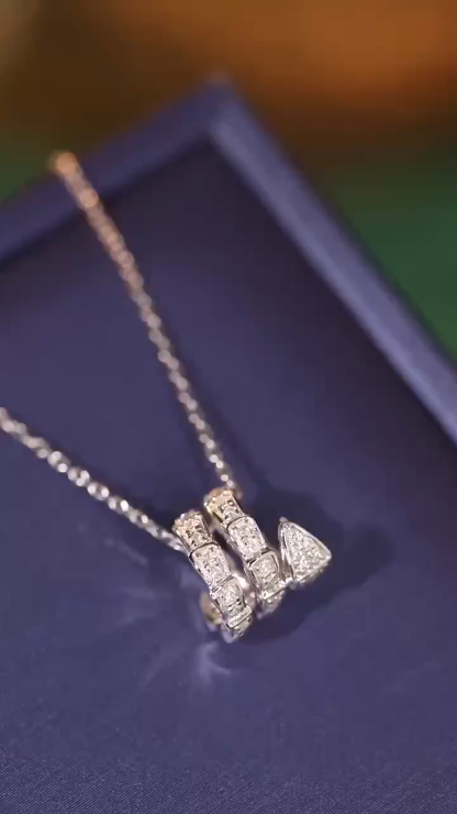 18k gold pendant in snake design, set with a 0.25ct diamond (chain not included)