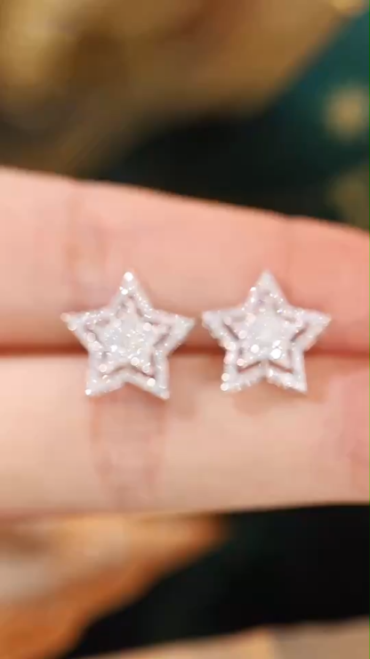 18k gold earrings in star shape, set with a natural diamond of 0.50 carats.