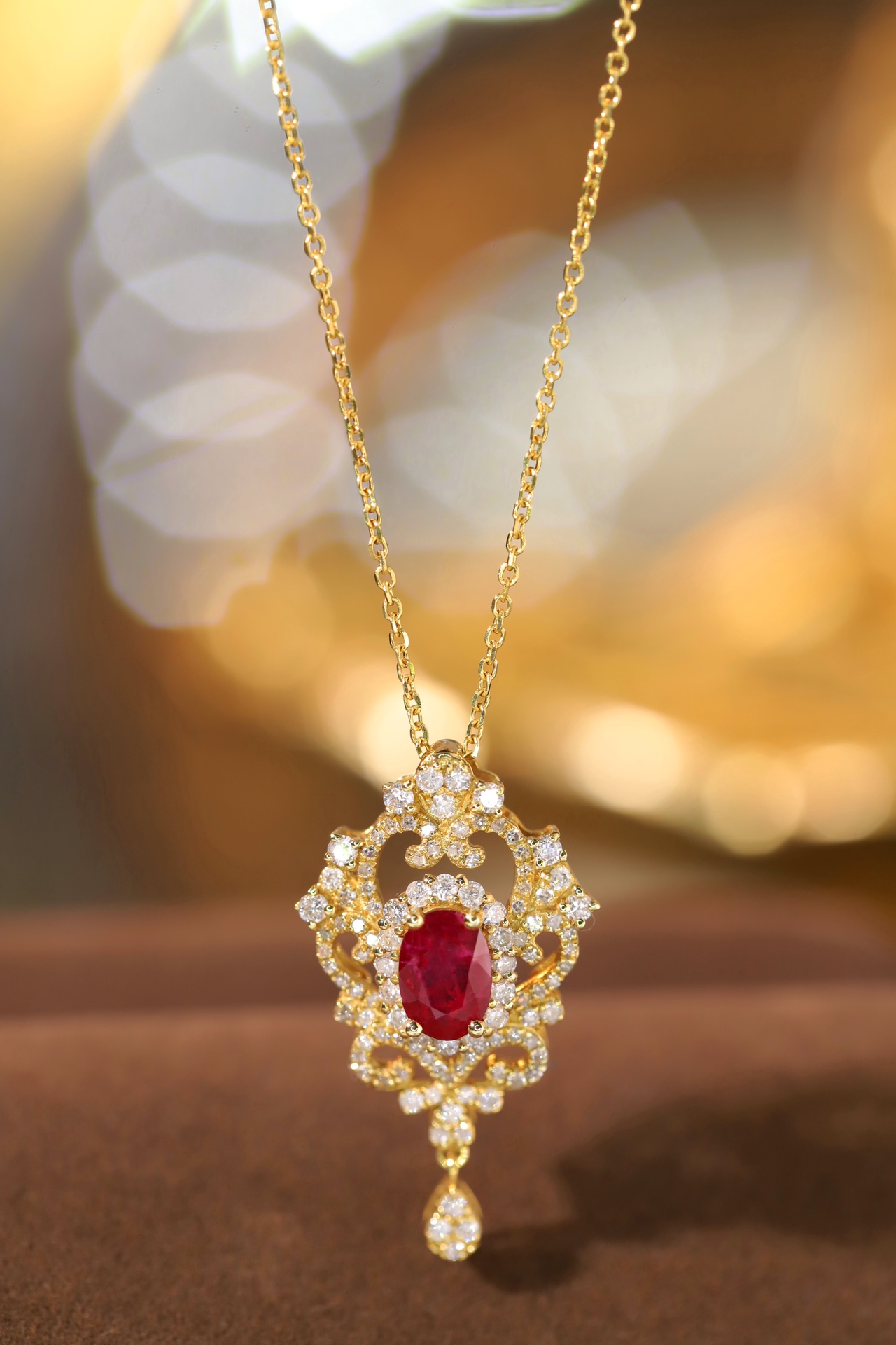 18K gold necklace with  design; the necklace is adorned with a 0.40-carat natural ruby and a 0.45-carat natural diamond, both set using the four-prong setting technique; the ruby has an oval shape.