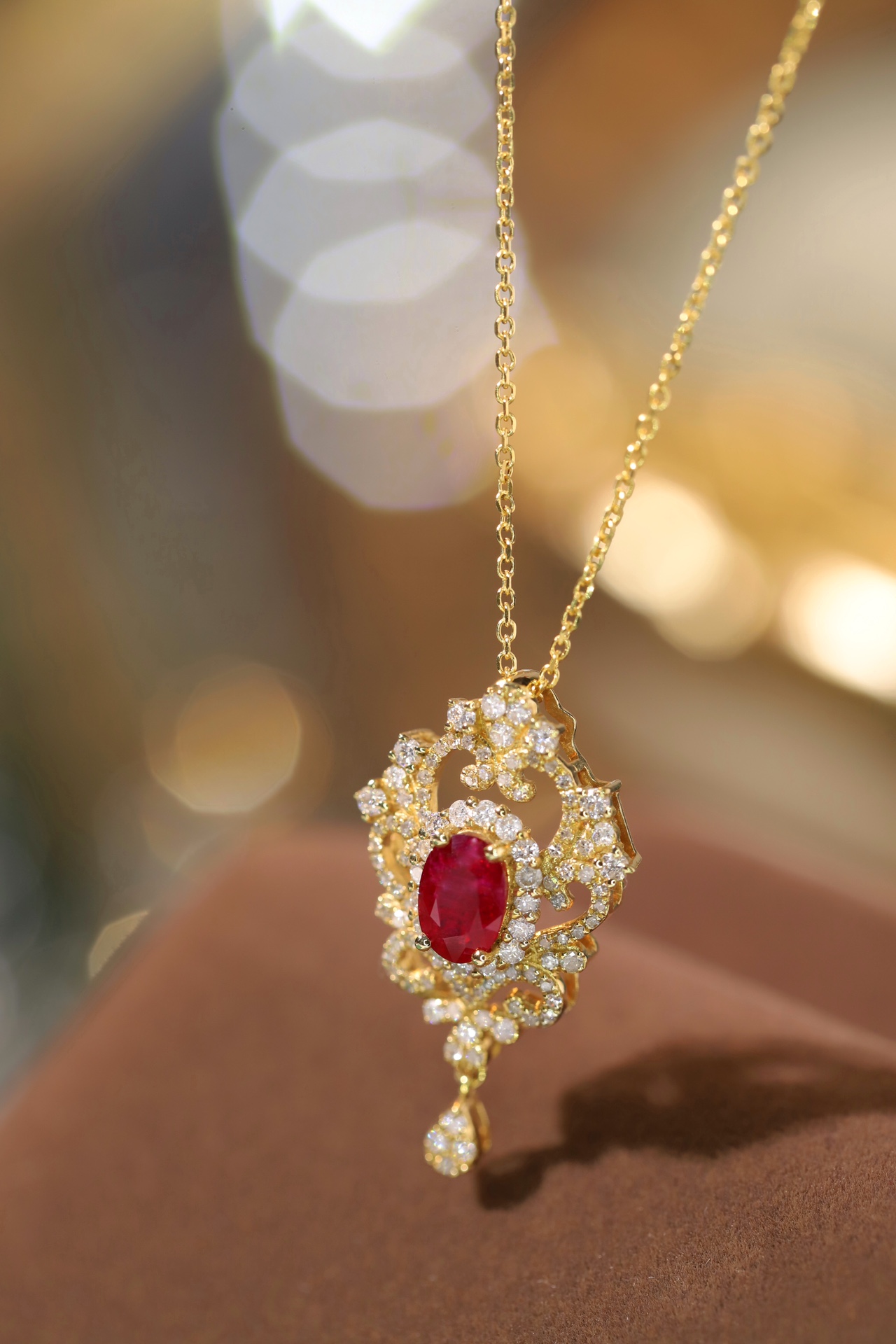 18K gold necklace with  design; the necklace is adorned with a 0.40-carat natural ruby and a 0.45-carat natural diamond, both set using the four-prong setting technique; the ruby has an oval shape.