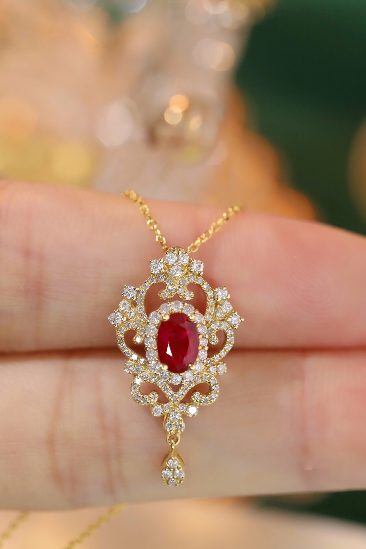 18K gold necklace with  design; the necklace is adorned with a 0.40-carat natural ruby and a 0.45-carat natural diamond, both set using the four-prong setting technique; the ruby has an oval shape.
