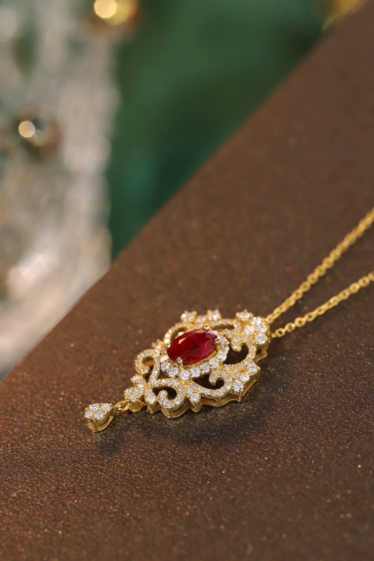 18K gold necklace with  design; the necklace is adorned with a 0.40-carat natural ruby and a 0.45-carat natural diamond, both set using the four-prong setting technique; the ruby has an oval shape.