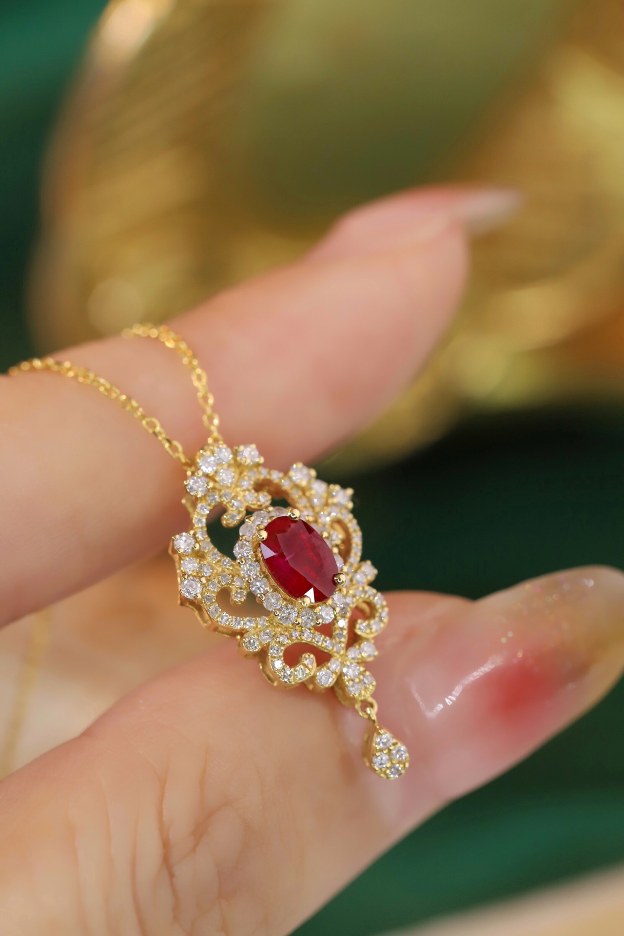 18K gold necklace with  design; the necklace is adorned with a 0.40-carat natural ruby and a 0.45-carat natural diamond, both set using the four-prong setting technique; the ruby has an oval shape.