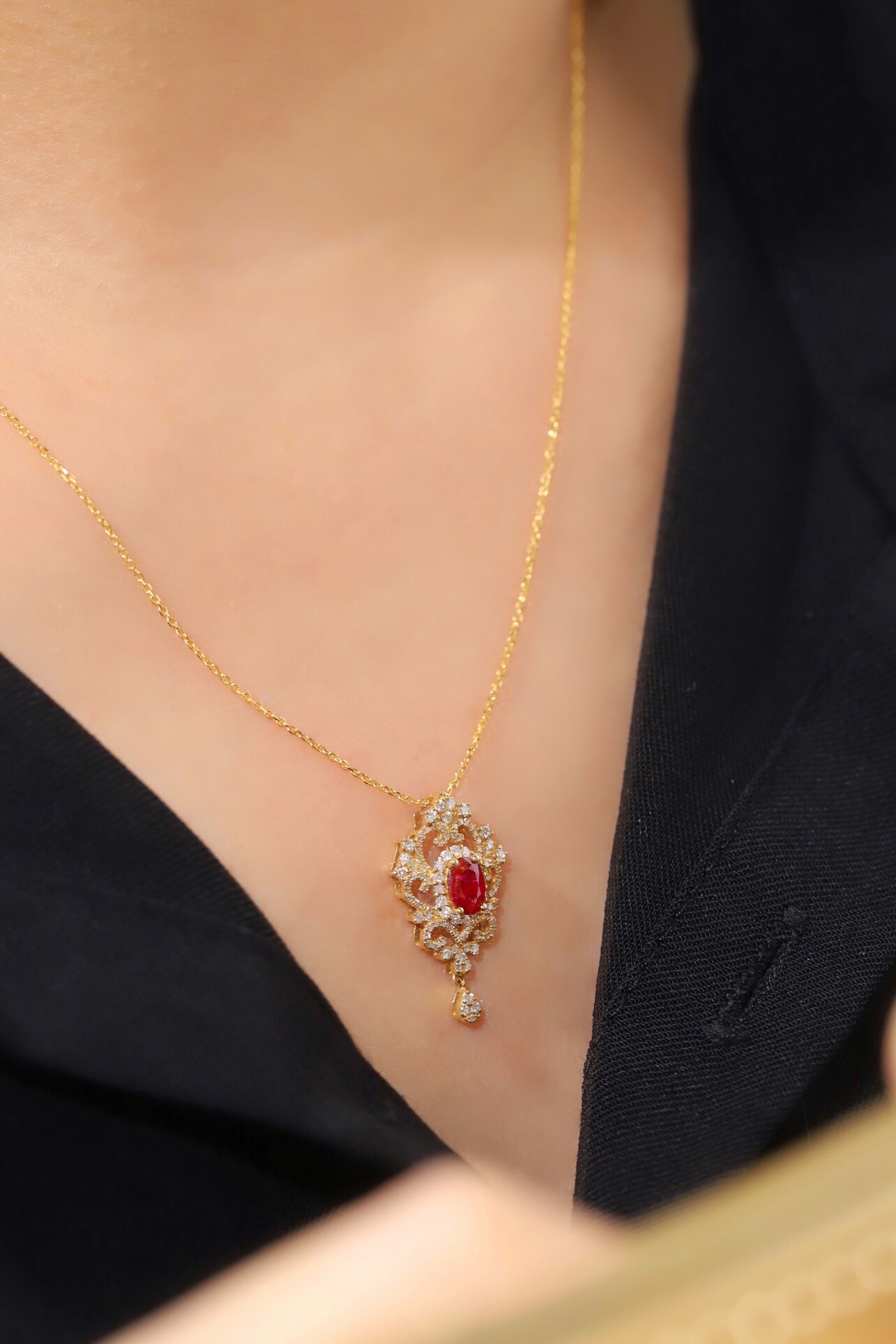 18K gold necklace with  design; the necklace is adorned with a 0.40-carat natural ruby and a 0.45-carat natural diamond, both set using the four-prong setting technique; the ruby has an oval shape.